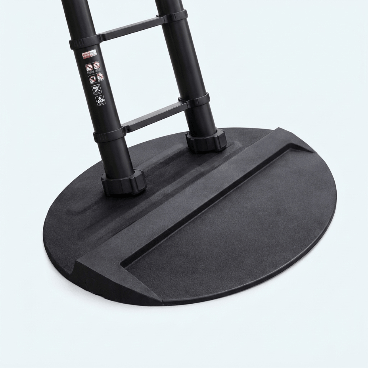 Close-up of the base of a black table or stand with two vertical legs and a wide circular platform, photographed on a very light gray background.